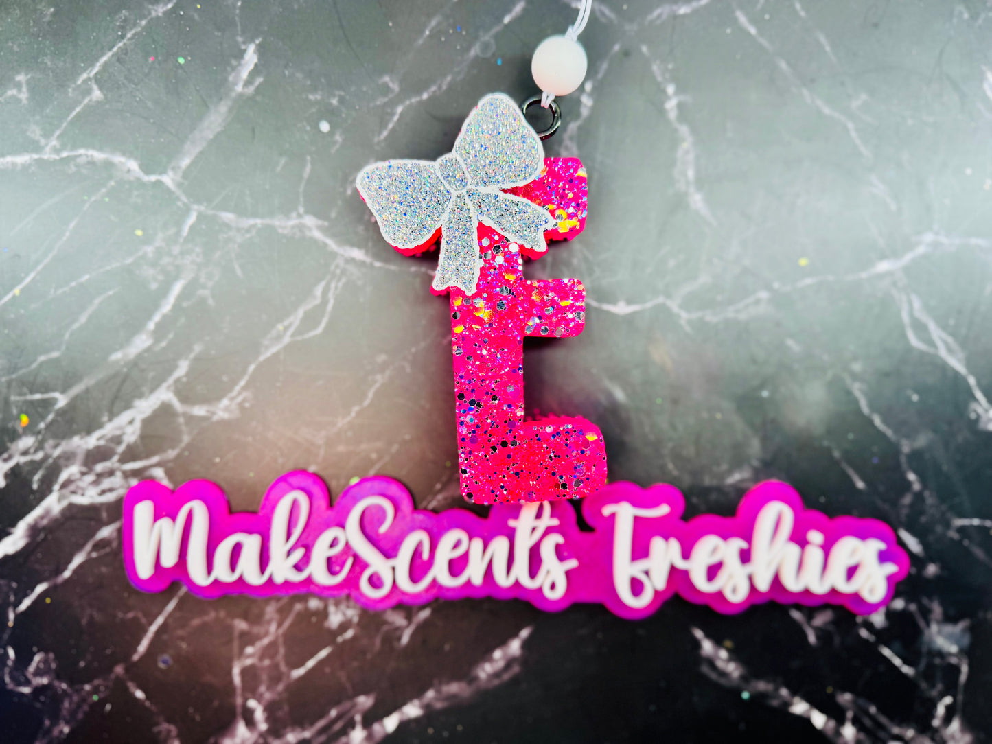 "E" with a bow