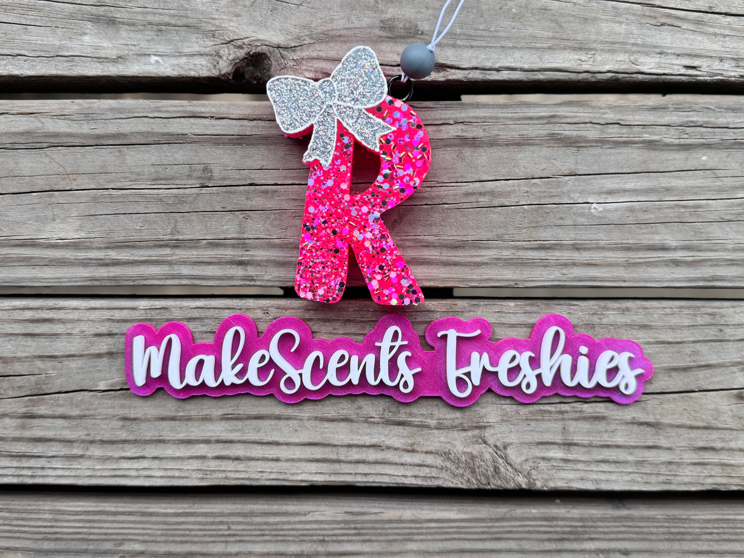 "R" with a bow