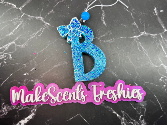 "B" with a bow
