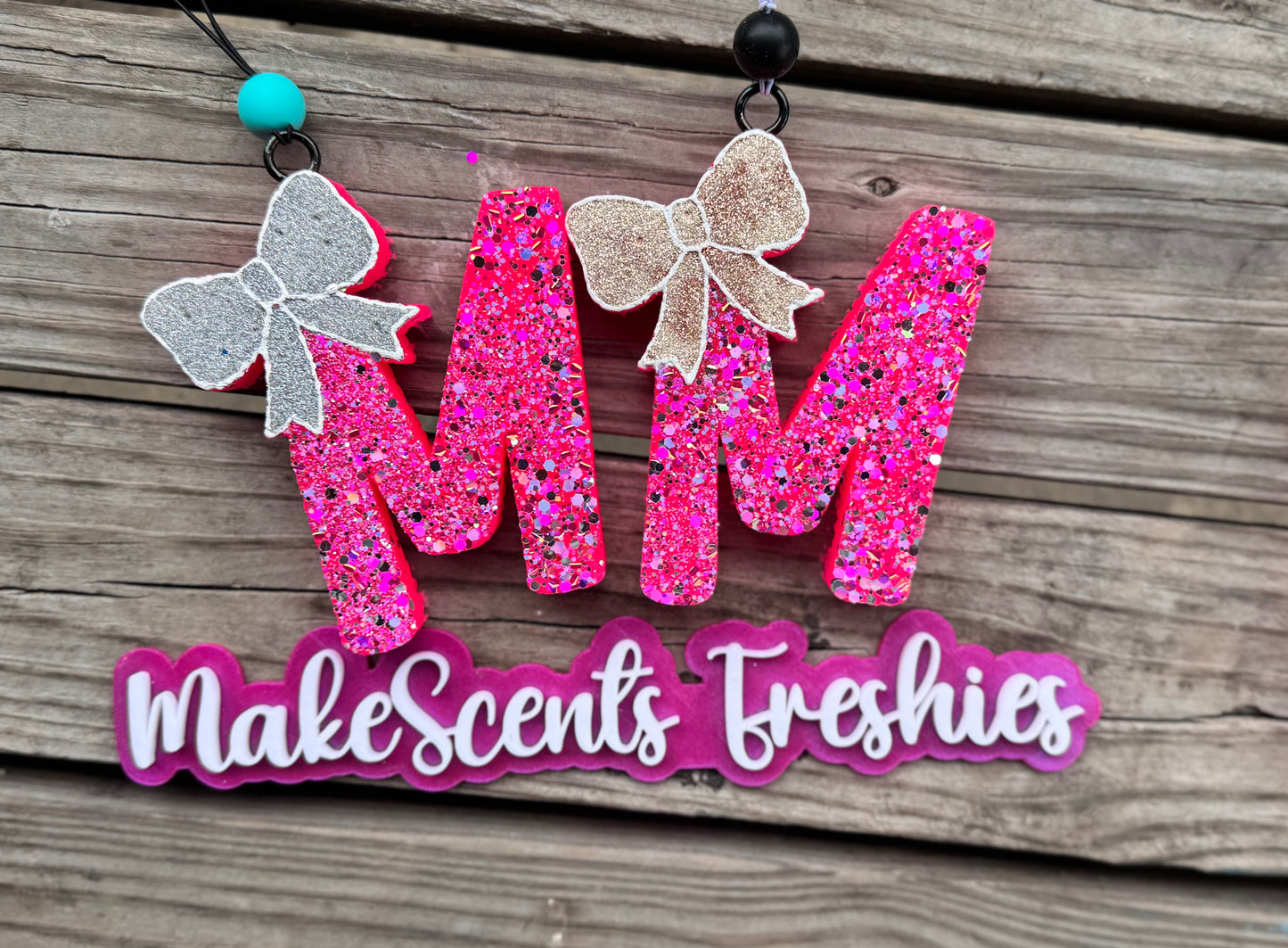 "M" with a bow